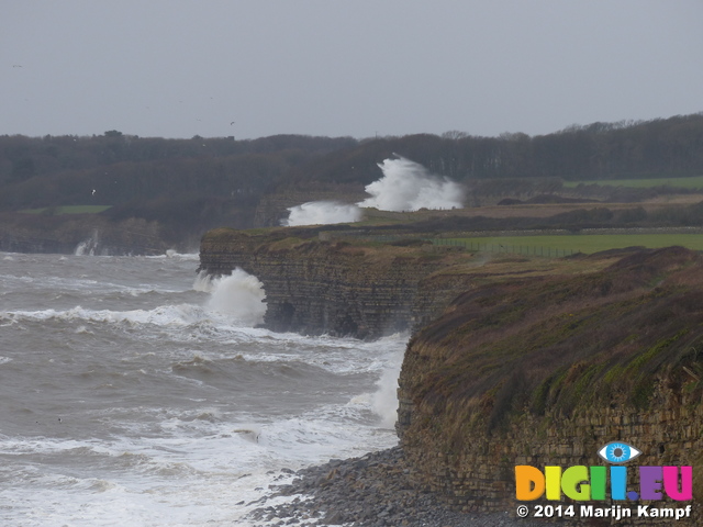 LZ00580 Waves crashing against cliffs at Llantwit Major beach